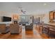 Open-concept living room with hardwood floors and a seamless flow to dining area at 6461 S Ider St, Aurora, CO 80016