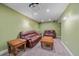 Finished basement living room with brown leather couches, projector, and sconce lighting at 6461 S Ider St, Aurora, CO 80016
