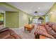 Finished basement living room and workout space with sconce lighting and theater setup at 6461 S Ider St, Aurora, CO 80016