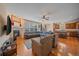 Open-concept living area with fireplace, hardwood floors, and adjacent kitchen at 6461 S Ider St, Aurora, CO 80016