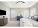 Bright bedroom with neutral walls, plantation shutters, and tray ceiling with fan creating a serene atmosphere at 3261 Trenton St, Denver, CO 80238