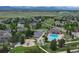 Aerial shot showcasing community pool, playground, and surrounding residences with mountain views in the distance at 14675 Golden Eagle Run, Broomfield, CO 80023