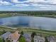 Aerial view of a tranquil community lake and surrounding residences showcasing natural beauty at 14675 Golden Eagle Run, Broomfield, CO 80023