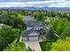 Aerial view of beautiful two-story home with lush greenery and mountain backdrop at 14675 Golden Eagle Run, Broomfield, CO 80023