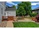 Landscaped backyard features a charming garden area and a walkway along the side of the house at 14675 Golden Eagle Run, Broomfield, CO 80023