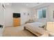 Bright bedroom features a comfortable bed, TV, natural light, and neutral decor for a relaxing atmosphere at 14675 Golden Eagle Run, Broomfield, CO 80023