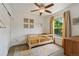 Bright bedroom with wood cot, ceiling fan, natural light, neutral paint, and carpeted floor at 14675 Golden Eagle Run, Broomfield, CO 80023