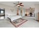 Spacious bedroom with a large bed, open floorplan and carpeted floor at 14675 Golden Eagle Run, Broomfield, CO 80023