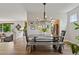 Open dining room with modern chandelier, seating for six, and hardwood flooring at 14675 Golden Eagle Run, Broomfield, CO 80023