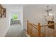 Bright hallway with natural light from a window and a staircase with wood banister at 14675 Golden Eagle Run, Broomfield, CO 80023