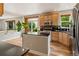 Kitchen with stainless steel appliances, wood cabinets, black countertops and breakfast bar at 14675 Golden Eagle Run, Broomfield, CO 80023