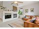 Cozy living room features a fireplace, comfortable leather seating, and stylish decor at 14675 Golden Eagle Run, Broomfield, CO 80023