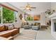 Spacious living room with a ceiling fan, plush seating, and large picture window at 14675 Golden Eagle Run, Broomfield, CO 80023