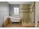 Elegant bathroom featuring a freestanding tub, tiled shower, and natural light from a window at 14675 Golden Eagle Run, Broomfield, CO 80023