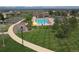 Community pool with clubhouse, colorful banners and manicured green lawn at 14675 Golden Eagle Run, Broomfield, CO 80023