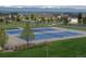 Well-maintained community tennis courts surrounded by green space and houses, backed by picturesque mountain views at 14675 Golden Eagle Run, Broomfield, CO 80023