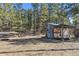 Rustic outbuilding in wooded area, with a simple door, creating a sense of retreat and seclusion at 21345 Cliffwoods Trl, Morrison, CO 80465