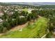 Picturesque aerial view of a lush golf course community with homes nestled among green trees at 1070 Cypress Way, Castle Rock, CO 80108