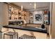 Inviting bar area featuring custom shelving, accent lighting, and a modern countertop at 1070 Cypress Way, Castle Rock, CO 80108
