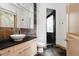 Modern bathroom with a vessel sink, stone backsplash, and a glass-enclosed shower at 1070 Cypress Way, Castle Rock, CO 80108