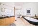 Bright bathroom offers a soaking tub with black countertops, and a glass enclosed shower at 1070 Cypress Way, Castle Rock, CO 80108