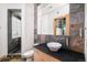 Bathroom with decorative mirror, stone walls and countertop, and glass enclosed shower at 1070 Cypress Way, Castle Rock, CO 80108