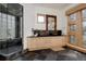 Stylish bathroom features a glass shower, vessel sink, and modern wooden cabinetry at 1070 Cypress Way, Castle Rock, CO 80108