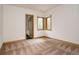 Bright bedroom with ample natural light, neutral decor, and a door leading to another room at 1070 Cypress Way, Castle Rock, CO 80108