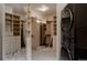 Large walk-in closet with built-in shelving and storage, next to washer and dryer at 1070 Cypress Way, Castle Rock, CO 80108