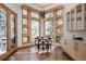 Bright dining area featuring a large window view, modern light fixture, hardwood floors, and built-in cabinets at 1070 Cypress Way, Castle Rock, CO 80108