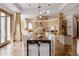 Elegant dining room with a long table, modern lighting, and easy access to the kitchen at 1070 Cypress Way, Castle Rock, CO 80108