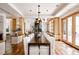 Open dining area with a large table, modern chandelier, and seamless flow to the living spaces at 1070 Cypress Way, Castle Rock, CO 80108