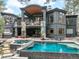 Stunning home exterior featuring a pool, patio, and elegant architectural design with balconies at 1070 Cypress Way, Castle Rock, CO 80108