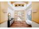Grand foyer with wood floors, high ceilings, stylish decor, and view to the outside at 1070 Cypress Way, Castle Rock, CO 80108