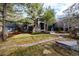 Beautifully landscaped front yard with mature trees and interesting rock detail at 1070 Cypress Way, Castle Rock, CO 80108
