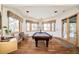 Bright game room features a pool table, hardwood floors, and lots of natural light at 1070 Cypress Way, Castle Rock, CO 80108