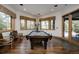 Spacious game room featuring a pool table, hardwood floors, and two large picture windows at 1070 Cypress Way, Castle Rock, CO 80108