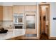 Kitchen featuring built-in oven and fridge with lots of light wood cabinets and marble countertops at 1070 Cypress Way, Castle Rock, CO 80108