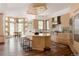 Spacious kitchen with hardwood floors, center island with seating, modern appliances, and lots of natural light at 1070 Cypress Way, Castle Rock, CO 80108