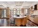 Open kitchen featuring a center island, hardwood floors, modern appliances, and an attached dining area with nature views at 1070 Cypress Way, Castle Rock, CO 80108
