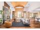 Comfortable living room with a stone fireplace and large windows offering scenic views at 1070 Cypress Way, Castle Rock, CO 80108