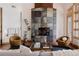 Living room with hardwood floors, a stone fireplace, and comfortable seating for a cozy ambiance at 1070 Cypress Way, Castle Rock, CO 80108