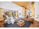 Bright, open-concept living room with wood floors, modern furnishings, and easy access to the kitchen and entry at 1070 Cypress Way, Castle Rock, CO 80108