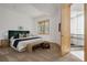 Bright main bedroom featuring a large window, stylish decor, and an ensuite bathroom at 1070 Cypress Way, Castle Rock, CO 80108