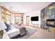 Sunlit main bedroom features a cozy seating area, fireplace, and scenic outdoor views at 1070 Cypress Way, Castle Rock, CO 80108