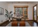 Bright office features a wooden desk, a large picture window, and a striped rug at 1070 Cypress Way, Castle Rock, CO 80108