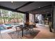 Covered outdoor dining area with a built-in kitchen, pizza oven, fire pit and view of the pool at 1070 Cypress Way, Castle Rock, CO 80108