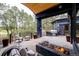 Relaxing outdoor patio featuring a built-in grill, fire pit, and comfortable seating with views of the surrounding landscape at 1070 Cypress Way, Castle Rock, CO 80108