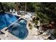 Tranquil pool area with waterfall feature, lounge seating, and lush landscaping at 1070 Cypress Way, Castle Rock, CO 80108