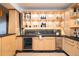 Well-lit wet bar with stone backsplash, built-in shelving, stainless steel wine cooler and beverage refrigerator at 1070 Cypress Way, Castle Rock, CO 80108